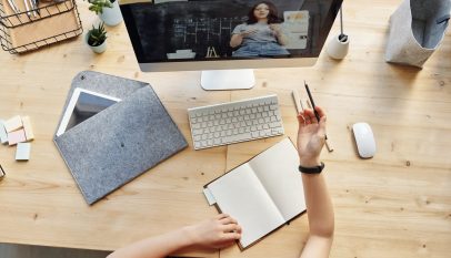 top view photo of girl watching through imac