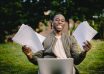 student with documents and laptop happy about getting into university