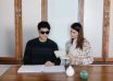 photo of people sitting together beside wooden table