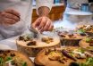 chef preparing vegetable dish on tree slab