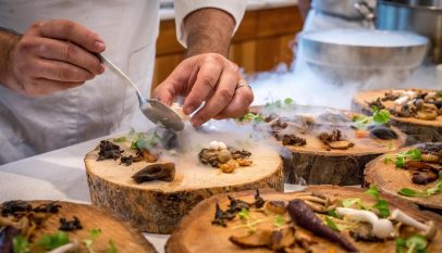 chef preparing vegetable dish on tree slab