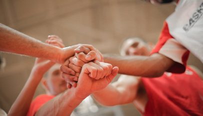 basketball team stacking hands together