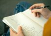 person writing a to do list