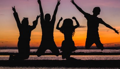 silhouette of people jumping