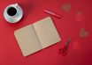 empty notepad near coffee and paper hearts