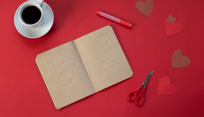 empty notepad near coffee and paper hearts