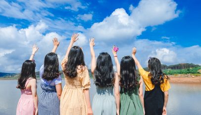 women standing near river