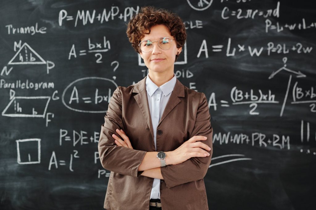 photo of woman standing in front of blackboard