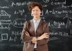 photo of woman standing in front of blackboard