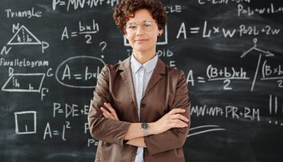 photo of woman standing in front of blackboard