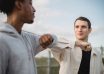 diverse friends greeting each other with elbows
