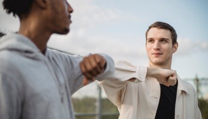 diverse friends greeting each other with elbows
