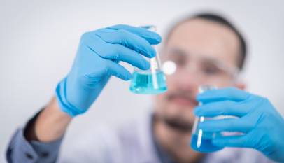 person holding glass flasks