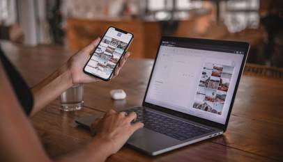 woman using smartphone and laptop